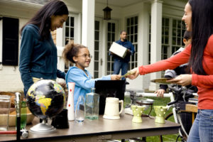 Woman buying item at yard sale