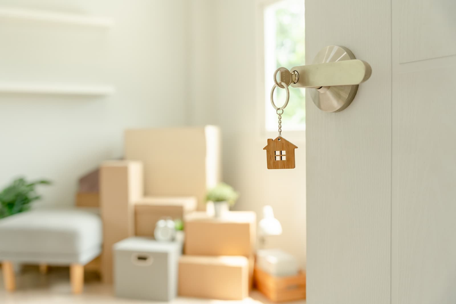 House keys hanging in the door with packed moving boxes inside a new home during an Orlando residential move.