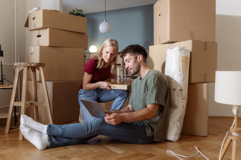 Couple surrounded by moving boxes while planning a residential move with professional movers in Melbourne, Florida.